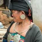 A woman from the A Ke ethnic minority people, in treditional costume, wearing silver jewlery. A Ke Village, Meng Hai County, Yunnan Province, China, Asia. Nikon D4, 24-120mm, f/4.0, VR