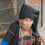 A very old woman from the A Ke ethnic minority people, smoking her pipe. A Ke Village, Meng Hai County, Yunnan Province, China, Asia. Nikon D4, 24-120mm, f/4.0, VR