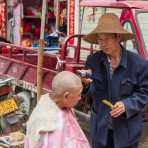 Skilled barber with electric razor attending a customer. Jin Ping market, Yunnan Province, China, Asia. Nikon D4, 24-120mm, f/4.0, VR