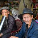 Two men taking a break at Jia Yin market, Yunnan Province, China, Asia. Nikon D4, 24-120mm, f/4.0, VR