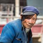 An old man at the Yuan Yang market, Yunnan Province, China, Asia. Nikon D4, 70-200mm, f/2.8, VR II