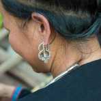 A woman from the Lanten people ethnic minority wearing her traditional costume, particular of her earring, Luang Namtha Province. Lao PDR, Indochina, South East Asia