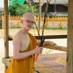 A novice buddhist monk affected by albinism, Vientiane. Lao PDR, Laos, Indochina, South East Asia.