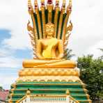Large Buddha statue sourrounded by the 7 snakes, Naca, symbol of good luck, temple in Vientiane province. Lao PDR, Laos, Indochina, South East Asia