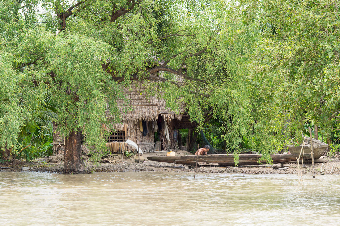 A man working on a  dugout canoe, Kaladan river, Rakhine State, Myanmar, Indochina, South East Asia.