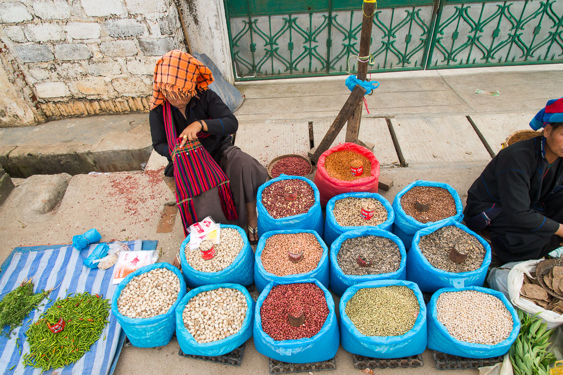 A woman selling dry seed, peanuts and other dry products. The market in Taunggyi, the capital of Shan State. Myanmar, Indochina, South East Asia.