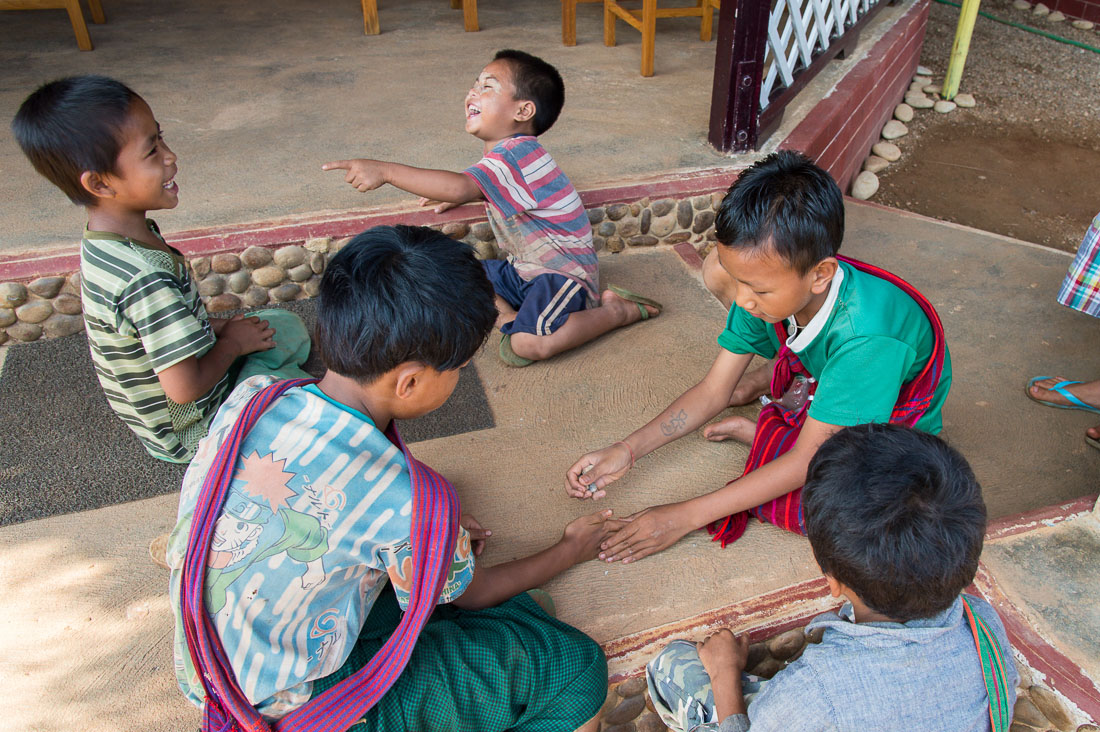 Children happily playing with pebbles during school break, Inle lake, Shan State, Mynamar, Indochina, South East Asia.