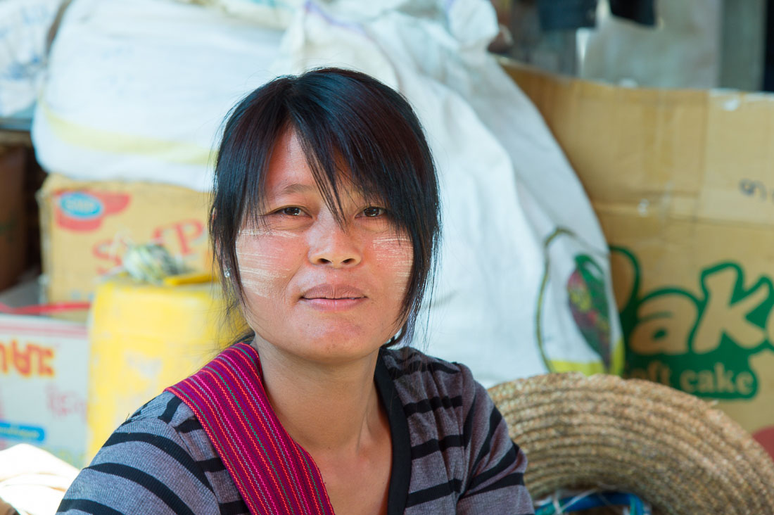 A beautiful woman with Tha Nat Khar on her face at Nanpam Village market, Inle Lake, Shan State, Mynamar, Indochina, South East Asia.