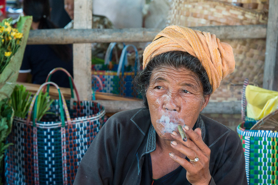 Woman from the Pao people ethnic minority group, enjoying a cigar at Nanpam Village market, Inle Lake, Shan State, Myanmar, Indochina, South East Asia.