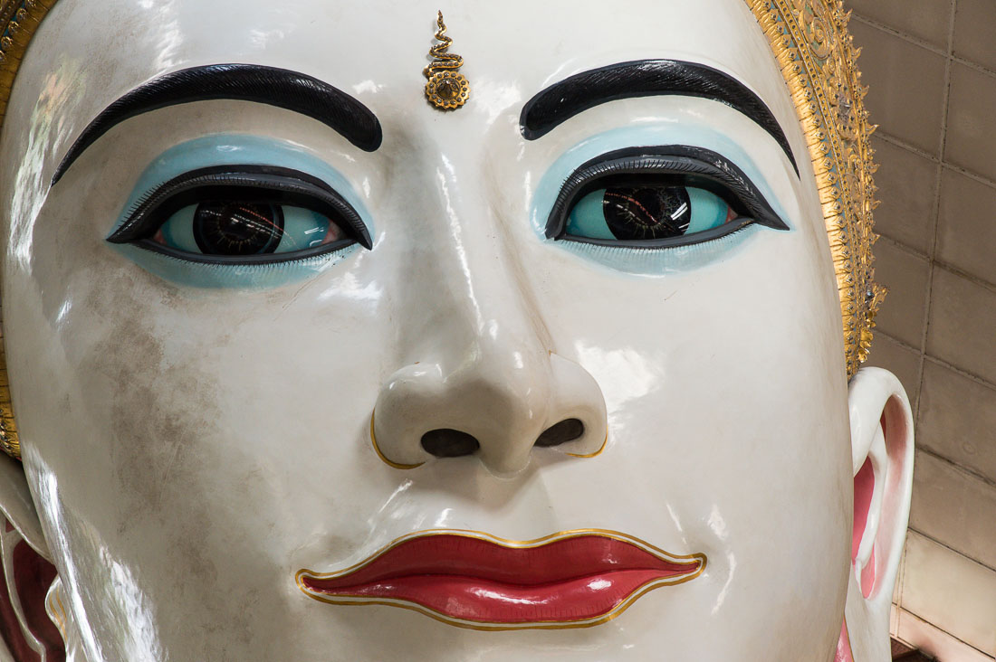 Head close-up of colossal staute of reclining Buddha at Chaukhtatgyi Paya, Yangon, Myanmar, Indochina, South East Asia.