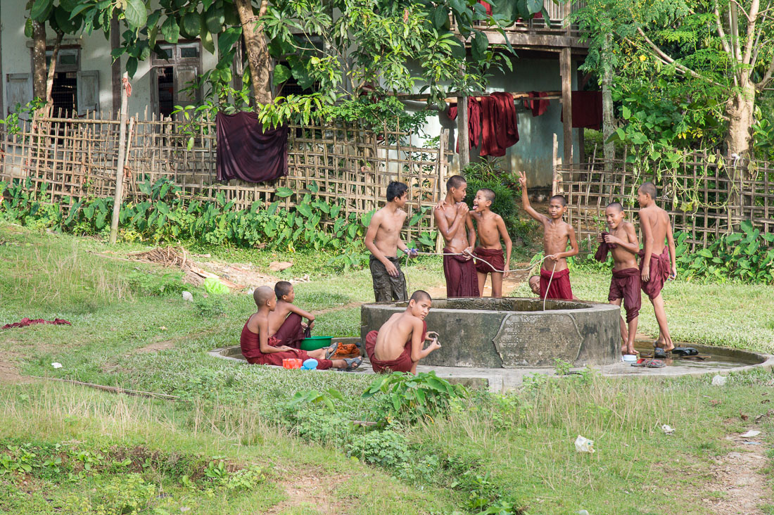 Young novice Buddhist monks taking a bath in late afternoon, Mrauk U Village, Rakhine State, Myanmar, Indochina, South East Asia.