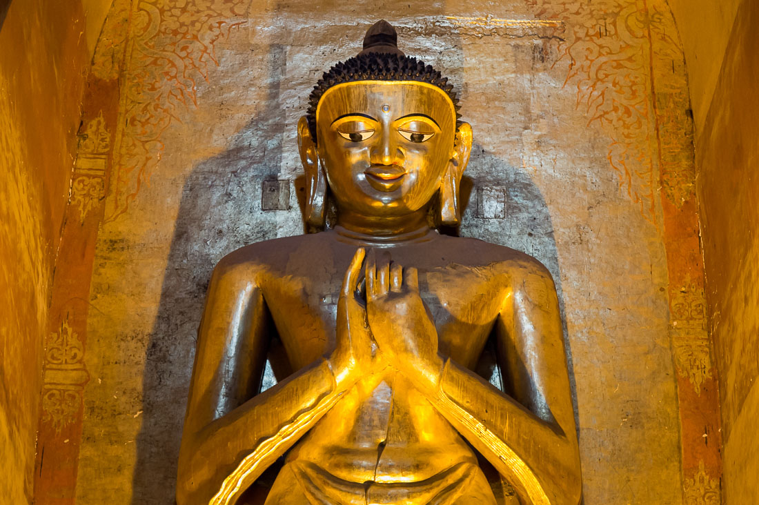 12 century statue of Buddha covered with gold leaves at Ananda temple in Bagan. Mandalay Province, Myanmar, Indochina, South East Asia.