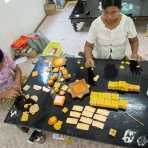 Preparing gold leaves used to cover Buddha statues and pagodas. Mandalay, Myanmar, Indochina, South East Asia.