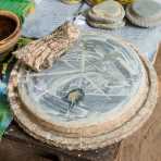 Roots and grinding plate to prepare Tha Nat Khar a natural cosmetic most Burmese women and man put on their face and arms for sun protection. Mingo Village, Sagaing Province, Myanmar, Indochina, South Easr Asia.