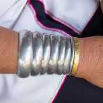 Metal bracelets of a woman from the Kayan people ethnic minority, known as 'giraffe women' because of  their elongated neck caused by the brass coils they wear since children. Bagan, Mandalay Province, Myanmar, Indochina, South East Asia.