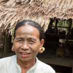 Old woman with the face full covered from spider web tattos, a mysterious and old tradition which was practiced until 60 years ago. There are 7 villages on the Lamro river with about 20 old women left with spider web tattoos on their face, all aged more than 65 years. Chin Village, Rakhine State, Myanmar, Indochina, South East Asia.