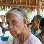 Old woman with the face full covered from spider web tattos, a mysterious and old tradition which was practiced until 60 years ago. There are 7 villages on the Lamro river with about 20 old women left with spider web tattoos on their face, all aged more than 65 years. Chin Village, Rakhine State, Myanmar, Indochina, South East Asia.