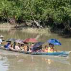 Small skiff loaded with  villagers going to the market in Mrauk U, Kaladan river, Rakhine State, Myanmar, Indochina, South East Asia.