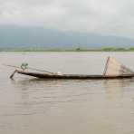 A fisherman with his creel, traditionally leg rowing, Inle Lake, Shan State, Myanmar, Indochina, South East Asia.