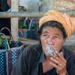 Woman from the Pao people ethnic minority group, enjoying a cigar at Nanpam Village market, Inle Lake, Shan State, Myanmar, Indochina, South East Asia.