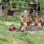 Young novice Buddhist monks taking a bath in late afternoon, Mrauk U Village, Rakhine State, Myanmar, Indochina, South East Asia.