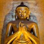 12 century statue of Buddha covered with gold leaves at Ananda temple in Bagan. Mandalay Province, Myanmar, Indochina, South East Asia.