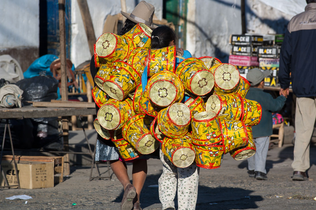 Women carrying straw baskets at the market in Huaraz, Peru, South America