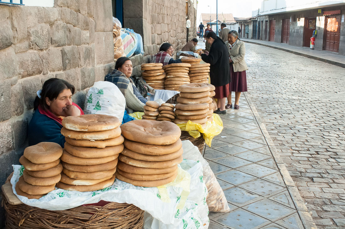 Women selling bred on the street of Cuzco, nearby the market, Peru, South America