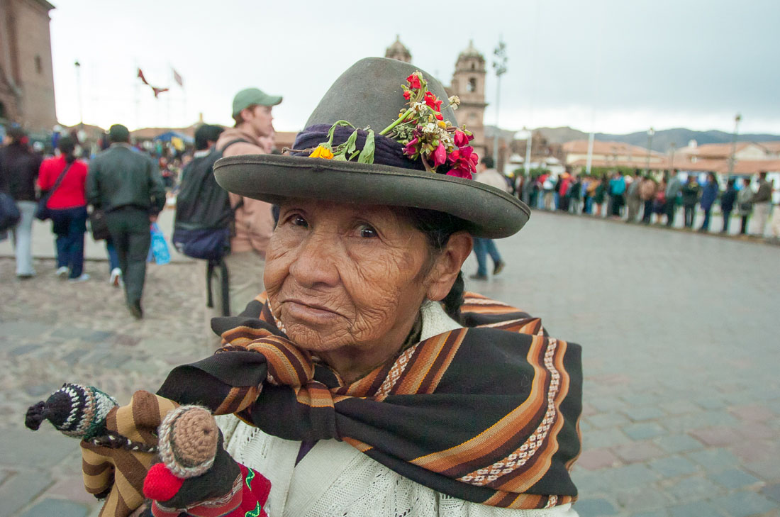 Woman in traditional costume selling little dolls, Cusco, Peru, South America