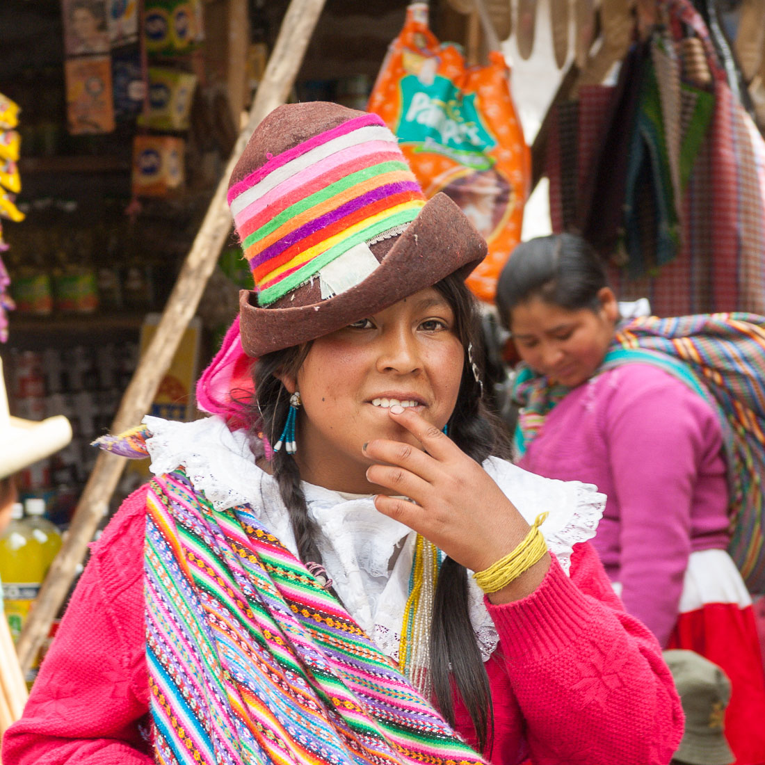 Young woman wearing traditional costume and hat at the market in Chavin, Peru, South America