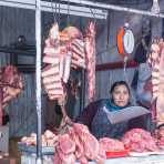 A butcher selling meat at Cuzco market, Peru, South America