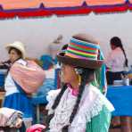 Young woman wearing traditional costume and hat at the market in Chavin, Peru, South America