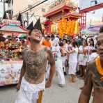 Followers of the Bang New Shrine taking part in a street procession during the annual Chinese vegetarian festival, with a custom made vehicle carrying the statue of a turtle sprying sacred water. Phuket, Kingdom of Thailand, Indochina, South East Asia