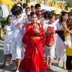 Female psychic medium follower of the Bang New Shrine with a rod pierced through her cheek, taking part in a street procession during the Chinese annual vegetarian festival. Phuket, Kingdom of Thailand, Indochina, South East Asia