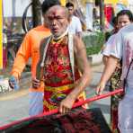 Psychic medium follower of the Bang New Shrine, bleeding from a self inflicted injury on his forehead, during a street procession of the annual Chinese vegetarian festival. Phuket, Kingdom of Thailand, Indochina, South East Asia