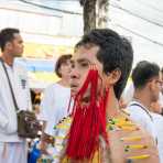 Psychic medium follower of the Bang New Shrine, with a bunch of needles pierced through his face and body, taking part in a street procession during the annual Chinese vegetarian festival. Phuket, Kingdom of Thailand, Indochina, South East Asia