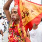 Psychic medium follower of the Bang New Shrine, with two long and thick needles pierced through his cheecks, taking part in a street procession during the annual Chinese vegetarian festival. Phuket, Kingdom of Thailand, Indochina, South East Asia