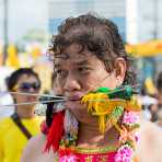 Psychic medium follower of the Bang New Shrine, with two long and thick needles pierced through his cheecks, taking part in a street procession during the annual Chinese vegetarian festival. Phuket, Kingdom of Thailand, Indochina, South East Asia