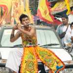 Psychic medium follower of the Bang New Shrine, with a large bore tool pierced through his cheeck, taking part in a street procession during the annual Chinese vegetarian festival. Phuket, Kingdom of Thailand, Indochina, South East Asia