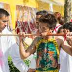 Psychic medium follower of the Bang New Shrine, with a billiard cue pierced through his cheeck, taking part in a street procession during the annual Chinese vegetarian festival. Phuket, Kingdom of Thailand, Indochina, South East Asia