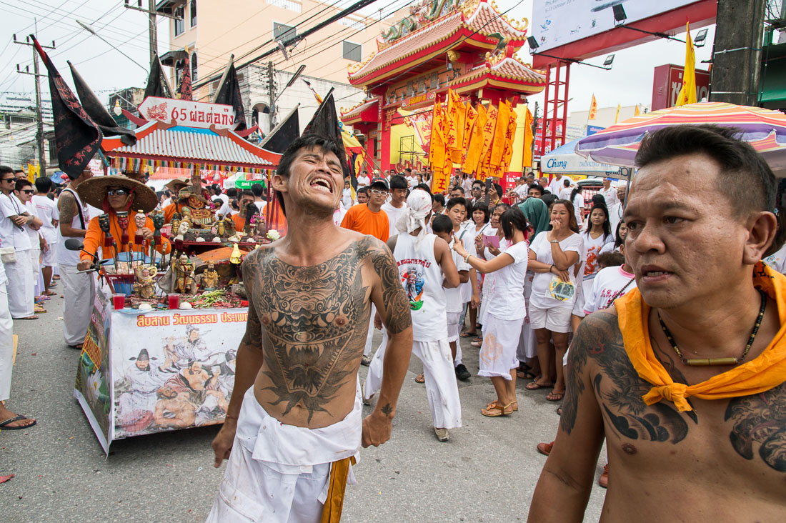 Followers of the Bang New Shrine taking part in a street procession during the annual Chinese vegetarian festival, with a custom made vehicle carrying the statue of a turtle sprying sacred water. Phuket, Kingdom of Thailand, Indochina, South East Asia