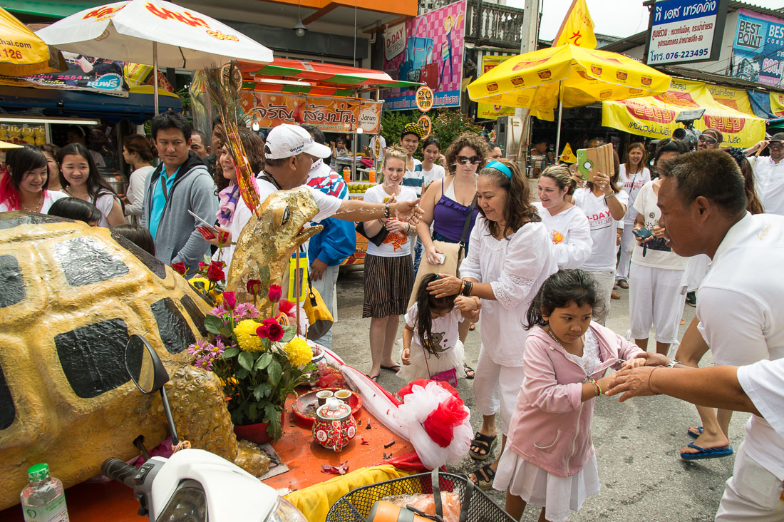 Followers of the Bang New Shrine taking part in a street procession during the annual Chinese vegetarian festival, with a custom made vehicle carrying the statue of a turtle sprying sacred water. Phuket, Kingdom of Thailand, Indochina, South East Asia