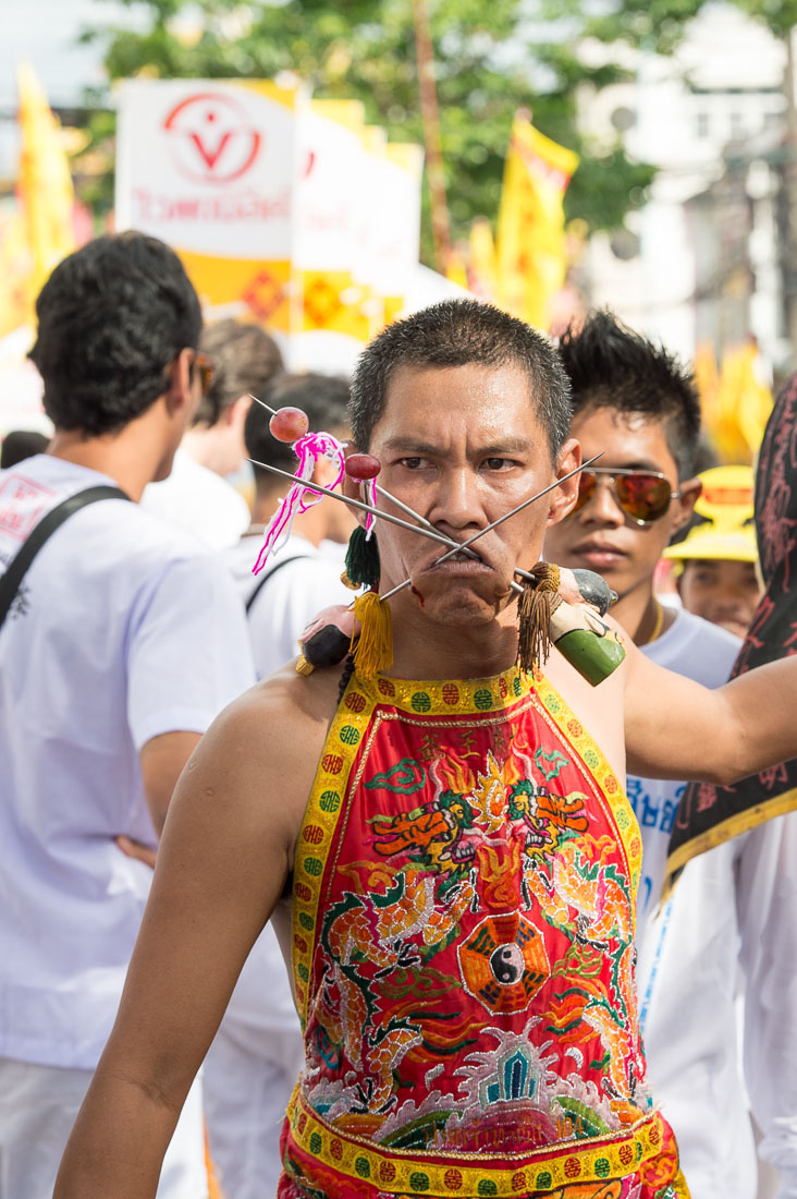 Psychic medium follower of the Bang New Shrine, with two long and thick needles pierced through his cheecks, taking part in a street procession during the annual Chinese vegetarian festival. Phuket, Kingdom of Thailand, Indochina, South East Asia