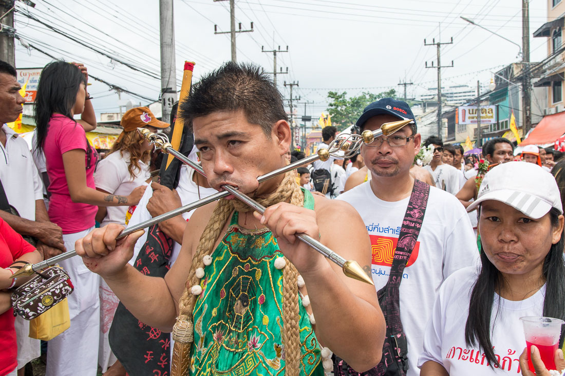 Psychic medium follower of the Bang New Shrine, with thick and thick rods pierced through his cheecks, taking part in a street procession during the annual Chinese vegetarian festival. Phuket, Kingdom of Thailand, Indochina, South East Asia