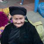 An old woman from the Nung people ethnic minority, wearing traditonal clothes. Viet Nam, Indochina, South East Asia.