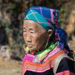 Old woman from the country side, belonging to Red Hmong people ethnic minority, wearing traditional costume, Ha Giang province. Viet Nam, Indochina, South East Asia.