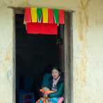 A mother from the Black Hmong people ethnic minority, sitting with her child at the door of her home, Ha Giang province. Viet Nam, Indochina, South East Asia.