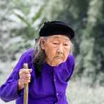 A very old woman from the Nung people ethnic minority group, wearing traditional clothes. Lang Son Province, Viet Nam, Indochina, South East Asia.