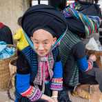 Woman from the Dao people ethnic minority group, wearing turban hat and traditional clothes. Lung Phin market, Ha Gang province, Viet Nam, Indonesia, South East Asia