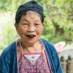 Very old woman from the Dao people ethnic minority group, showing her blackened teeth and the stained red lips from chewing areca nuts. Ngon Tue Village, Yen Bai Province, Viet Nam, Indochina, South East Asia.